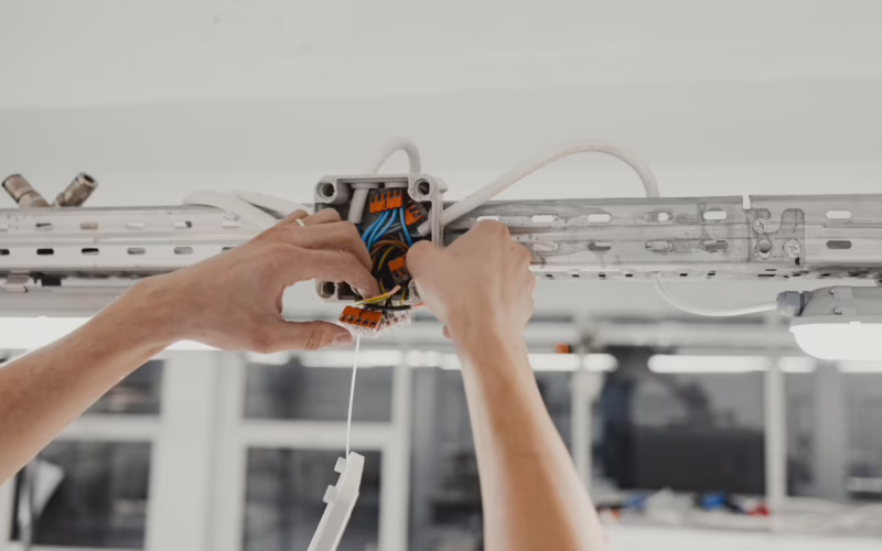 Electrical Expertise in Action, Junction Wiring Installation with Skilled Hands in Close-up view